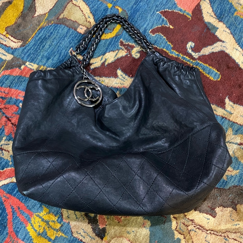 Authentic vintage black Chanel tote bag with silver hardware and a pouch inside